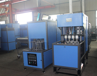 Machine de soufflage de bouteilles PET semi-automatique à 4 cavités contrôlée par PLC avec roulement de moteur pour bouteilles d'eau en plastique à petite échelle