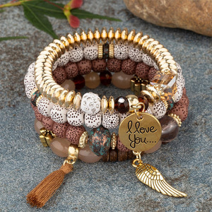 Juego de 4 pulseras bohemias para mujer, pulseras elásticas multicapa apilables con dijes de alas, borlas y cuentas de cristal, regalo de joyería. - Product Image 1