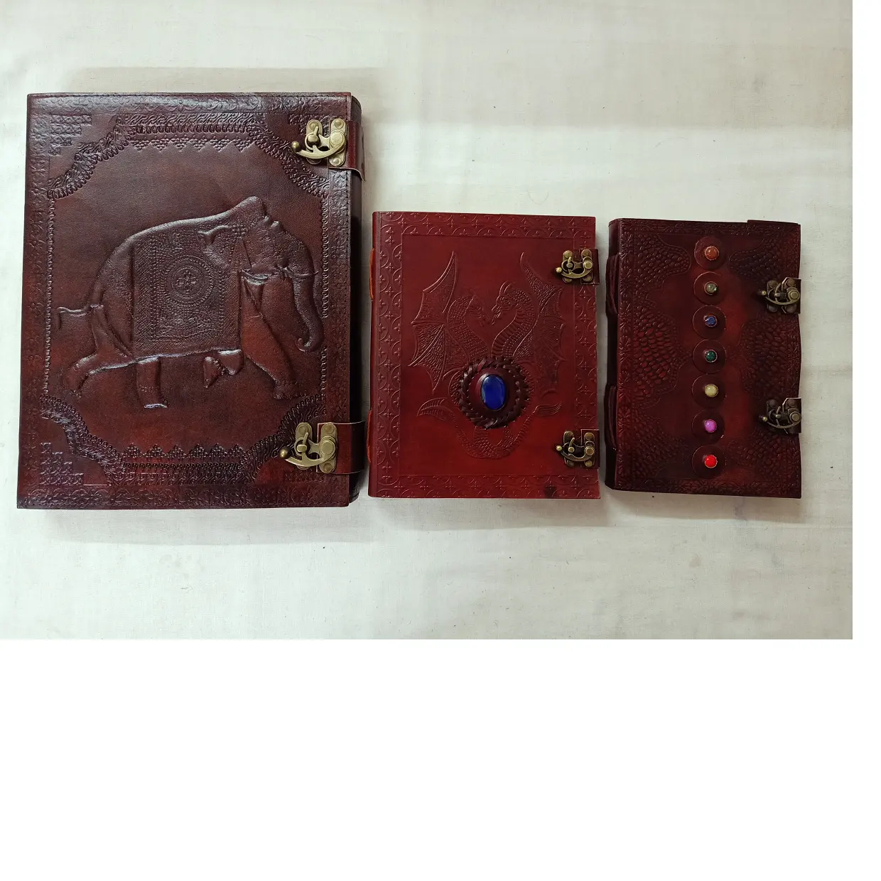 custom made leather journals in large size with indian elephant embossed cover , dragon embossed cover and 7 chakra stone cover