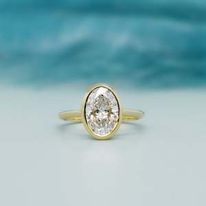 Oval Engagement <b>Ring</b> in Yellow Gold with Bezel Set <b>Diamond</b> Elegant <b>Diamond</b> <b>Rings</b> Collection - Product Image 1