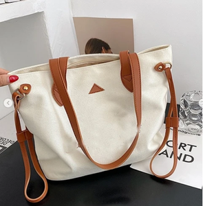 Stylish cream canvas tote with tan handles and pockets. Perfect for daily use. Available at wholesale prices. - Product Image 1