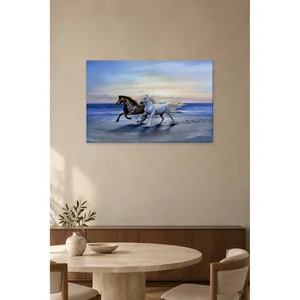 Impression sur toile de chevaux noirs et blancs courant sur la plage par Fida - Product Image 1