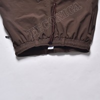 Pantalon de neige haute performance marron, imperméable et coupe-vent, avec isolation polaire et taille élastiquée pour adultes