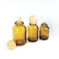 Bouteille ronde de parfum ambré de luxe avec pulvérisateur 30ml 50ml 100ml Bouteille en verre vide avec bouchon à bille pour dame