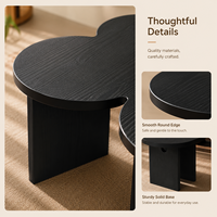 Table basse moderne écologique en forme de trèfle noir avec finition grain de bois pour salon et mobilier de maison