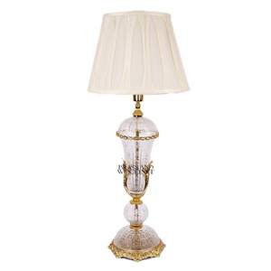 Luxury antique style <b>table</b> <b>lamp</b> crafted from golden brass with elegant fabric <b>shade</b> and artistic engraved base design - Product Image 1