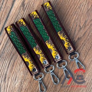 พวงกุญแจหนังแท้ลายดอกไม้ตะวันตกสุดหรูใหม่สายคล้องข้อมือสำหรับผู้หญิงสายคล้องข้อมือสำหรับใส่กุญแจรถทำจากโลหะ - Product Image 1