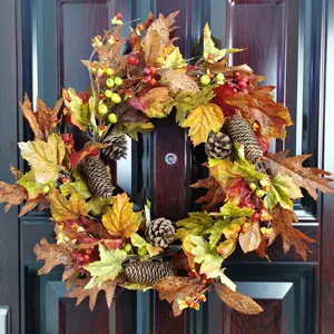 Autumn artificial maple leaves and green eucalyptus leaves vine decoration outdoor wreath