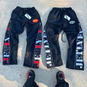 กางเกงไนลอนผู้ชายออกแบบได้ตามต้องการมีซิปน้ำหนักเบาพิมพ์ตัวอักษรน้ำหนักเบาเสื้อผ้าแนวสตรีทแบบลำลองกันน้ำ - Product Image 1