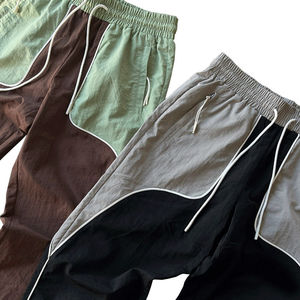 Pantalones de chándal de nailon reflectante para hombre, pantalones de chándal holgados acampanados, cintura elástica, diseño de retazos, ropa de estilo deportivo informal teñida - Product Image 1