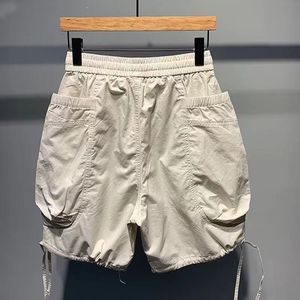 Grande poche tout-en-un ligne cordon Cargo Shorts hommes nouvel été couleur unie décontracté ample large jambe pantalon DDP expédition - Product Image 3