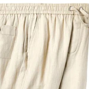 Sand linen <b>pants</b> with an elastic waist, button-fly, zippered side pocket, and sewn pleats, offering a breezy, relaxed fit - Product Image 5