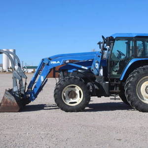Tracteur HOL LAND TM125 d'occasion, modèle 1051, avec chargeur auto-nivelant 72LA, godet à fixation rapide de 96 pouces avec grappin - Product Image 4