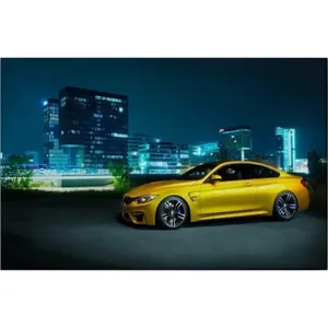 Impression sur toile de la BMW M4 jaune Fida dans les lumières de la ville nocturne - Product Image 6