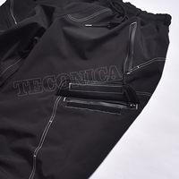 Pantalon de neige cargo unisexe imperméable noir avec surpiqûres contrastées, style ample et pantalon de ski isolé