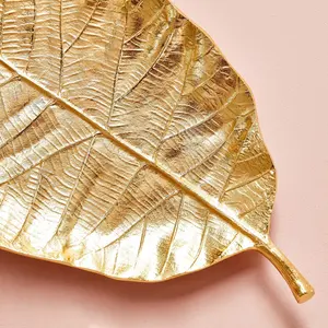 Plato de hojas decorativas de metal similar a las hojas de Magnolia macrophylla y Terminalia El plato es de color dorado - Product Image 2