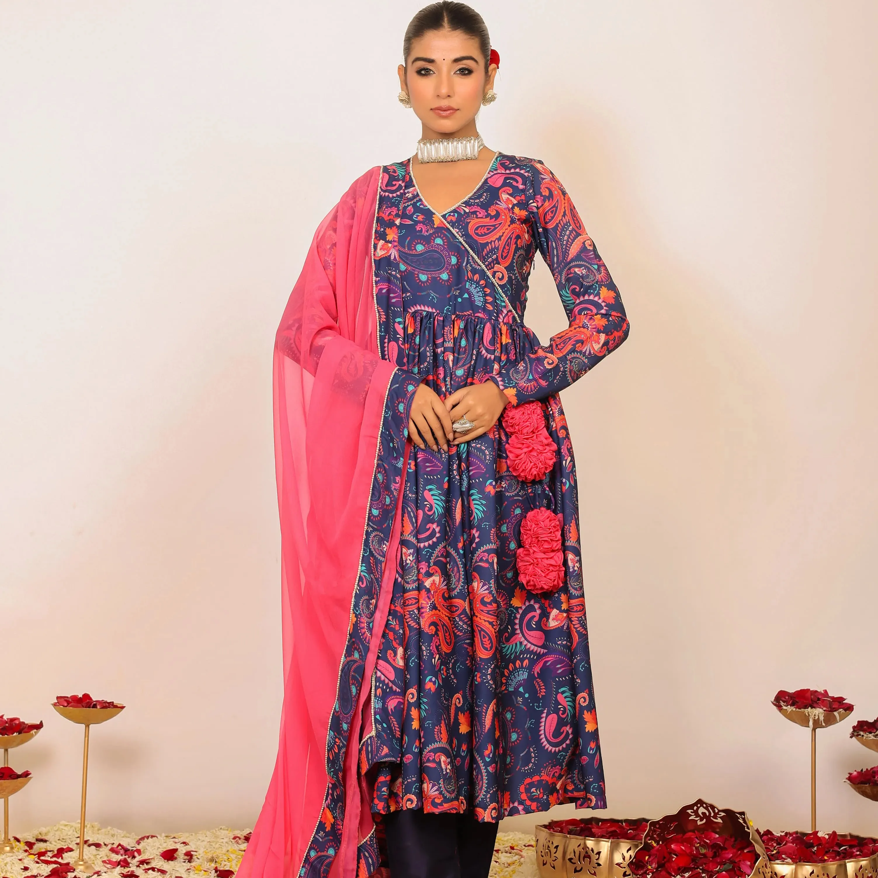 The mesmerizing combination of pink and blue creates a harmonious blend The Anarkali kurta and pant showcase intricate prints
