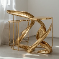 Table d'appoint moderne luxueuse avec dessus en métal véritable au design doré Base sculpturale unique Finition miroir pour le stockage