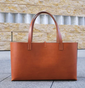 Simple, flat tan leather ladies <b>purse</b>, a clean, structured rectangular tote bag, available at wholesale prices now. - Product Image 1