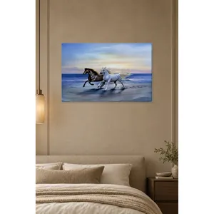 Impression sur toile de chevaux noirs et blancs courant sur la plage par Fida - Product Image 4