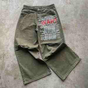 กางเกงยีนส์เอวสูงทรงแบ็กกี้ สไตล์วินเทจฟอกสี ขาดๆ แต่งกระดุม ทรงขาบาน สตรีทแวร์ฮิปฮอป - Product Image 3