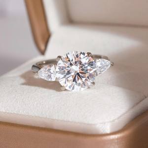 Anillo de compromiso de tres piedras CZ blancas de corte redondo de 10mm con piedras laterales de pera | Joyería nupcial de oro y plata - Product Image 1