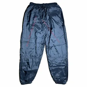 Pantalone antipioggia personalizzato a vento all'ingrosso a basso prezzo realizzato in tessuto 100% Nylon poliestere e tela