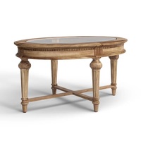 Table basse contemporaine d'aspect antique en bois de manguier massif avec plateau en verre ovale et pieds sculptés, fabriquée en Inde