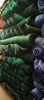 Venta al por mayor 100% de algodón peinado tejido de sarga respetuoso con el medio ambiente pesado liso teñido para niños niñas tela más grande de China
