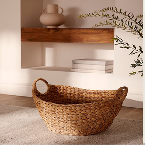 Es un artículo ancho y tejido con una base cuadrada o rectangular y dos asas grandes y redondeadas integradas en la parte superior. - Product Image 2