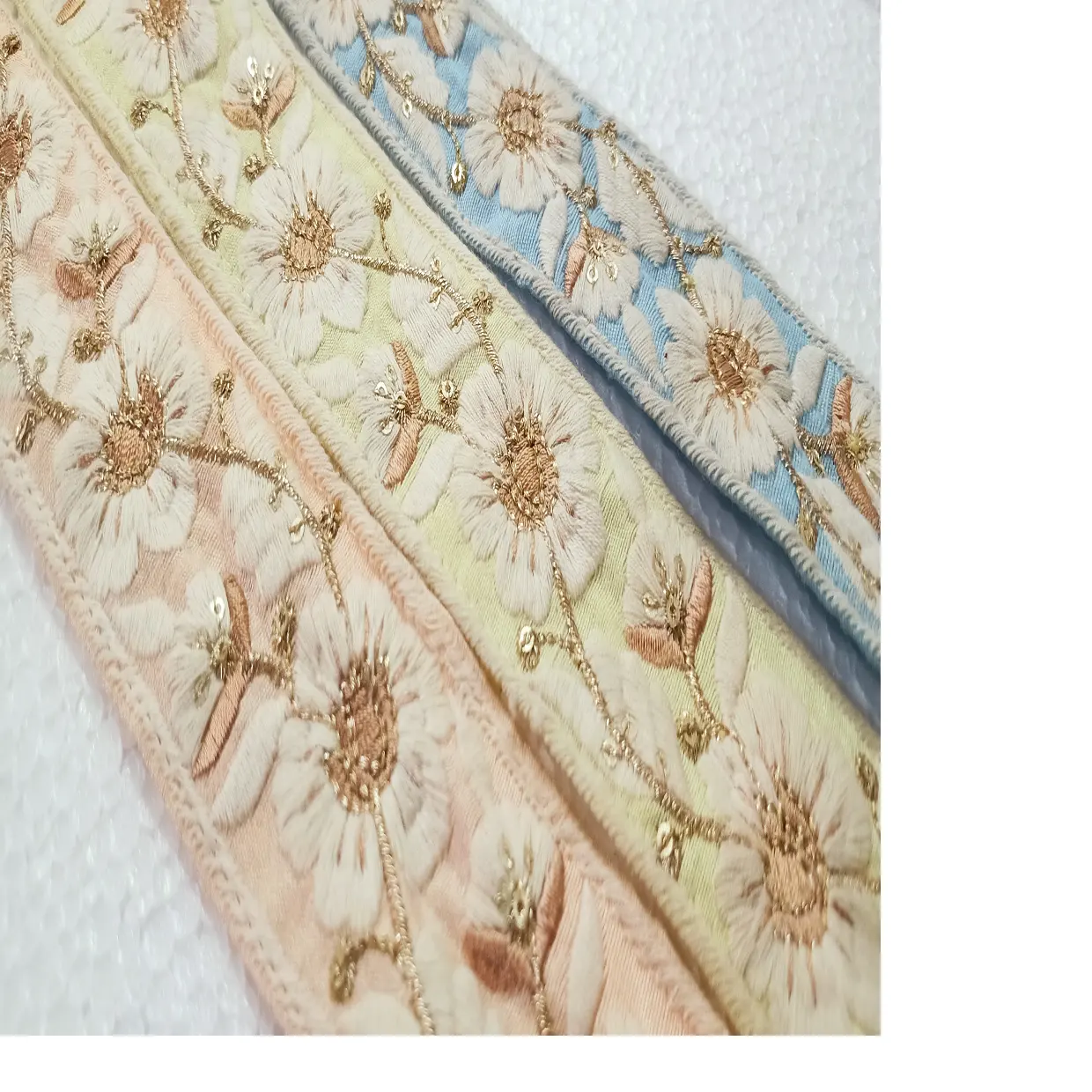 custom made machine embroidered laces in floral designs & in light pastel colours for wedding dresses in 1.5 inch width.