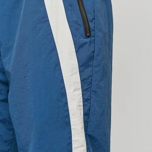 Pantalones de nailon de retazos personalizados para hombre, pantalones cortavientos de entrenamiento con bolsillo y cremallera, pantalones holgados para correr para hombre - Product Image 1