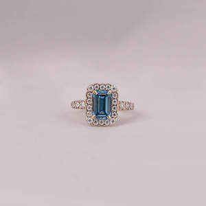 Fashionable Solitaire Blue Emerald Cut Lab Grown Diamond With Tiny Round Cut Diamond Halo Engagement Ring in 18KT <b>Solid</b> Gold - Product Image 1