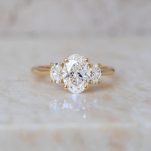 7x9mm Oval Cut White CZ Three <b>Stone</b> Engagement Ring with Round Side Stones in Gold Band Bridal Wedding Anniversary Jewelry - Product Image 1