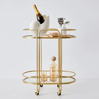 Chariot de service portable en métal à deux niveaux avec des étagères en verre élégantes pour la présentation de café ou de bar à vin de thé de l'après-midi