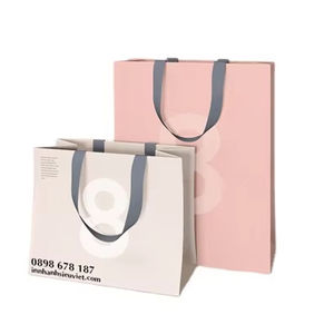 ถุงกระดาษคราฟท์สีขาวแบบกำหนดเองทนทานพร้อมที่จับสีชมพูและอุปกรณ์เสริมริบบิ้นสำหรับถุงกระดาษคราฟท์โลโก้ที่เป็นเอกลักษณ์ของคุณ - Product Image 1