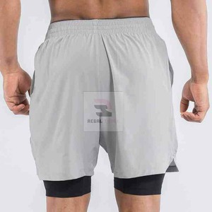 Pantalones cortos deportivos de doble capa con logotipo personalizado unisex con patrón sólido de cintura elástica y decoración informal de encaje - Product Image 6