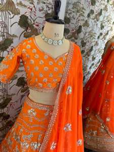 Resplandor en cada giro, esta vibrante lehenga naranja con intrincados bordados plateados es pura elegancia festiva. - Product Image 6