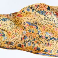 Kain Batik buatan tangan tradisional dengan latar belakang emas menyala motif bunga hidup dan kupu-kupu Ideal untuk modis