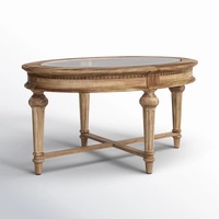 Table basse contemporaine d'aspect antique en bois de manguier massif avec plateau en verre ovale et pieds sculptés, fabriquée en Inde