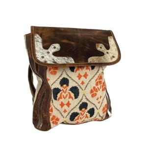 <b>Backpack</b> Hair on Cowhide Accents the Top Leather Flap and Sides& Copper Metal Accents Indian Manufacturer Supplier Saman Exports - Product Image 1