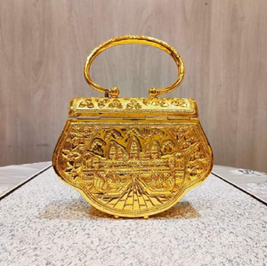 An elegant gold-toned clutch covered in a detailed gingko leaf pattern with a striking skull clasp. Available at wholesale price - Product Image 6