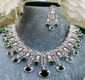 Collar de lujo con piedras preciosas de esmeraldas verdes en forma de lágrima con piedras transparentes brillantes y engastado en un metal plateado. - Product Image 1