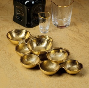 Gold shiny finish cast aluminum serving <b>bowl</b> with modern texture and deep <b>basin</b> designed for decorative and functional use - Product Image 1