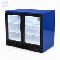 Réfrigérateur minibar à double zone de température pour hôtel, avec porte en verre trempé, adapté au réfrigération des boissons.