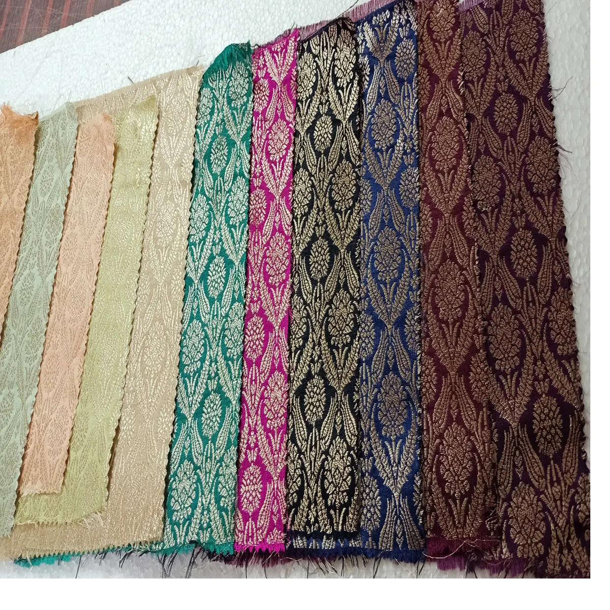 custom made in light pastel colours textured brocade silk fabrics with motifs for clothing designers & fabric stores for resale