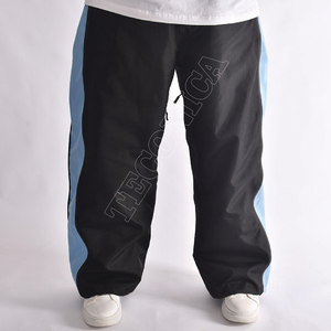 Pantalones Unisex Negros con Paneles Laterales Azules con Cierre Oculto, Cintura Ajustable con Cordón, Dobladillo Elástico y Corte Holgado Estilo Techwear - Product Image 2