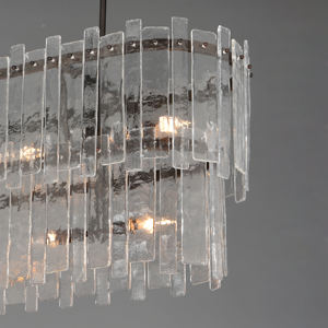 Paneles de vidrio fundido que se extienden con elegancia y una estética orgánica única envuelven anillos de metal de bronce oscuro. - Product Image 3