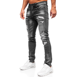 Wax coated <b>denim</b> jeans for men with slim fit design and leather look finish ideal for street fashion and trendy apparel buyers - Product Image 1