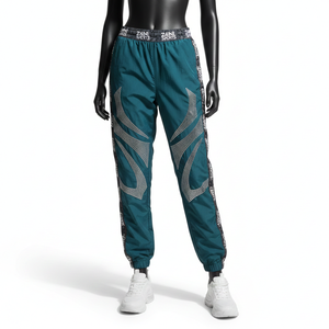 Pantalon coupe-vent pour femme, tissu en nylon tissé de qualité supérieure, couleur sarcelle, design de panneau latéral, logo jacquard personnalisé, pantalon coupe-vent - Product Image 1